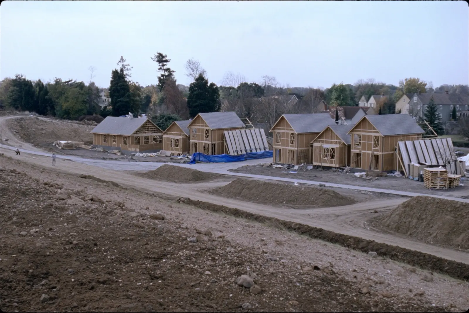 A new residential subdivision under construction at the edge of farmland.